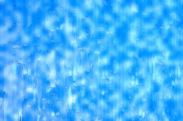 Blue dripping paint splatted stained wall. Used as background. Rough and grungy.