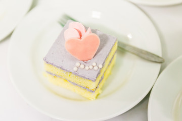 Cake have heart shaped on a plate against white background