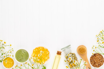 Spa still life with aromatherapy chamomile, herbal oil, soap, sea salt.