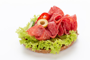 Sandwich with salami sausage on white background.