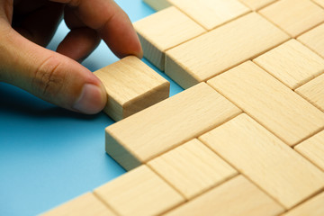 Hand lined wooden blocks on a blue background, Building a successful business team concept