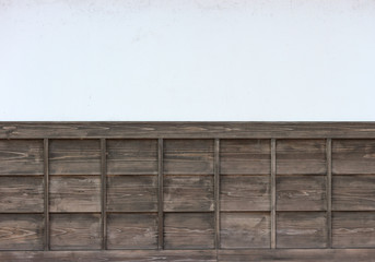 Japanese style old brown wood panels on white cement wall background.