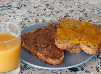 Slice toast with cocoa cream and peach jam on blue plate
