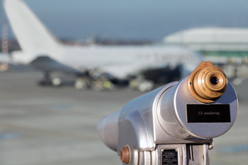 Visitors terrace with views over runway of International Airport with the airplane. Coin telescope...