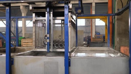 Cleaning metal parts in an ultrasonic bath at an enterprise, industrial ultrasonic cleaning