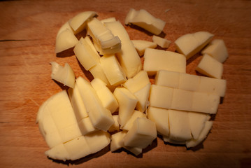 Obraz na płótnie Canvas Sliced sweet cheese on wooden table