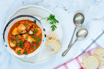 Tiger prawn and fish stew in a bowl- top view