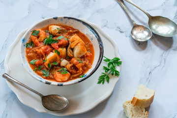 Tiger prawn and fish stew in a bowl- high angle view