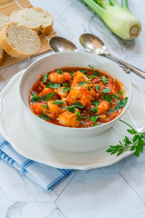Tiger prawn and fish stew in a bowl