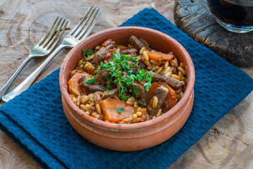 Giouvetsi - traditional Greek baked dish with beef and orzo pasta in tomato sauce.