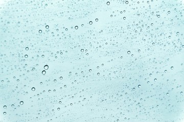 In selective focus many droplets on a mirror with blue background for backdrop texture 