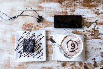 cappuccino and brownies in the wooden table