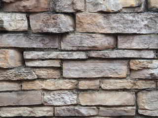 Masonry from different stones as texture, background and pattern.
