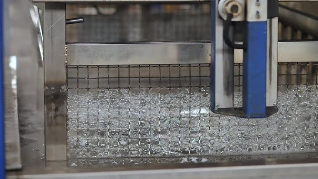 Industrial ultrasonic cleaning machine, cleaning metal parts in an ultrasonic bath
