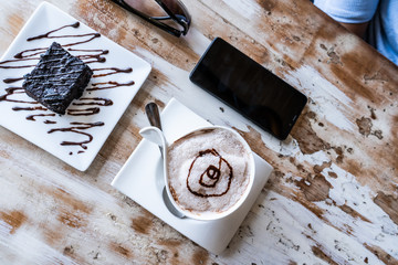cappuccino and brownies in the wooden table