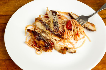 Grated Parmesan Cheese Melting on Blackened Chicken Breast on Pasta and Tomato Sauce