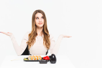 Attractive woman celebrating mad and crazy for success with arms raised and with sushi!