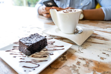 Chocolate brownie cake and coffee mug