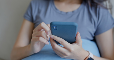 Close up of woman use mobile phone at home