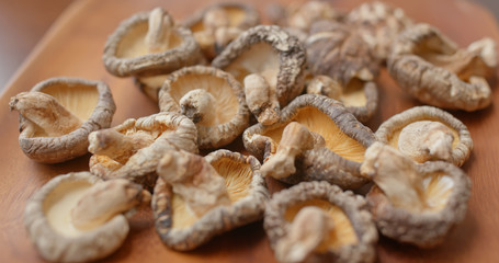 Stack of dry mushroom on wooden plate