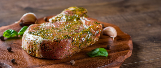 Raw Pork Loin chops marinated meat Steak for bbq on wooden table background