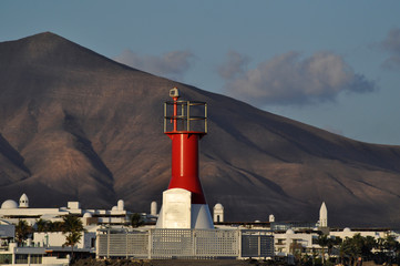 Red lighthouse on mountain background, Lanzarote Canarias island 