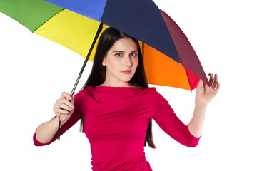 Young attractive woman under rainbow coloured umbrella