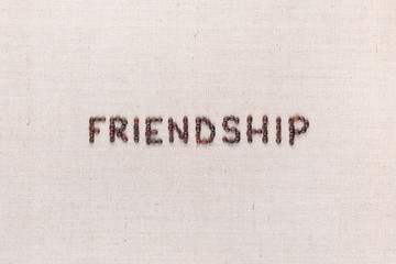 Friendship word written with coffee beans, aligned in the center.