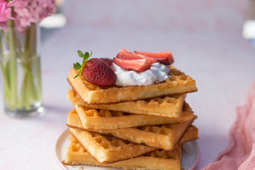Waffles with strawberries and whipped cream