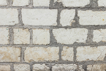 The brick texture, wall, with cracks and scratches can be used as a background