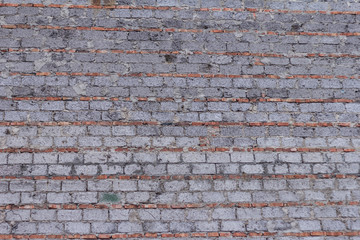 The brick texture, wall, with cracks and scratches can be used as a background