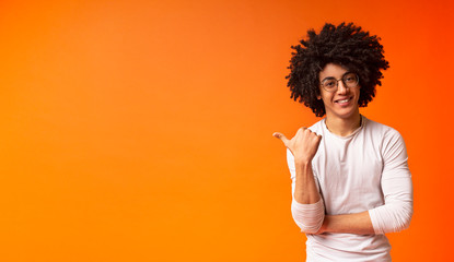 Confident african american black man pointing at free space