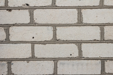 The brick texture, wall, with cracks and scratches can be used as a background