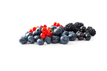 Ripe blueberries, currants and blackberries. Background of mix berries with copy space for text. Mix berries on white background. Berries isolated on white background.