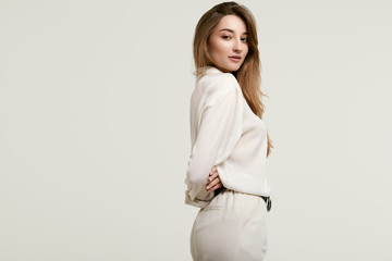 Gorgeous female brunette model in white clothes