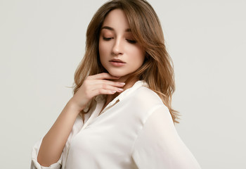 Gorgeous female brunette model in white clothes