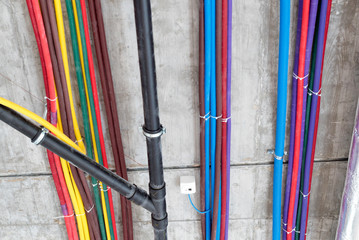 colorful plastic tubes for electrical wires in the sub ceiling in a massive wiring system