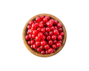 Top view. Berries viburnum in a wooden bowl. Viburnum isolated on white background. Viburnum with copy space for text. Berries viburnum isolated on white background. Ripe viburnum close-up.