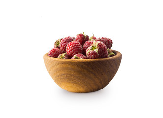 Raspberries in a wooden bowl isolated on white background. Raspberry closeup. Vegetarian or healthy eating. Juicy and delicious raspberries. Background of raspberries.  Red raspberries.