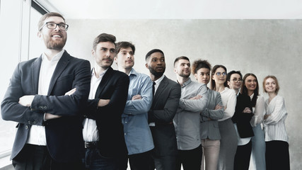 Successful business team standing in row at office