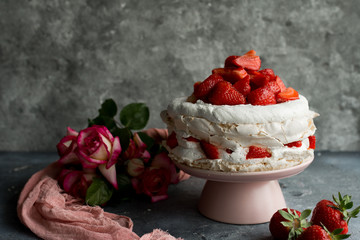 Pavlova with whipped cream and strawberries.