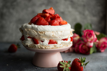 Pavlova with whipped cream and strawberries.