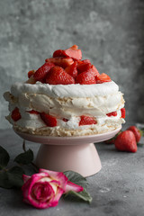 Pavlova with whipped cream and strawberries.