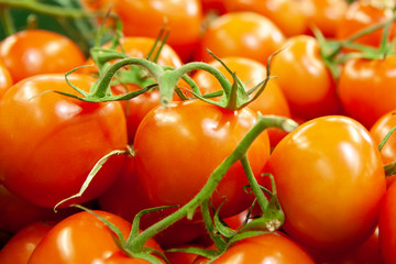 Fresh tomatoes piled on display for sale.