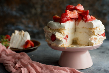 Cake with strawberries. Dark background.