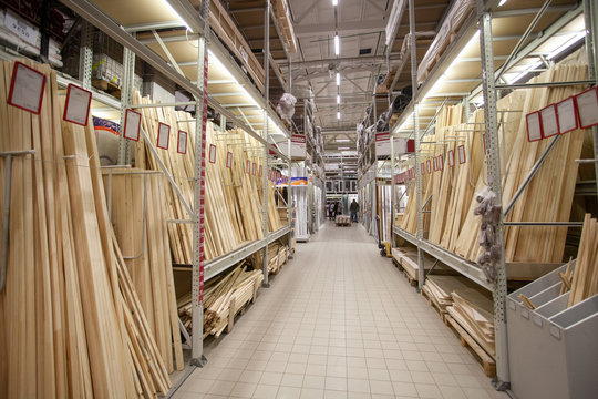Sale in DIY shopping center. Lumber warehouse with wooden planks. Professional retail market for carpenter and builder.
