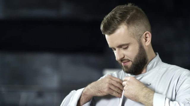 Chef man preparing to cook at professional kitchen. Portrait of happy male cook