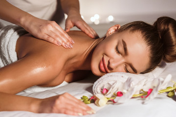 Total Relaxation. Woman Getting Back Massage In Spa Center