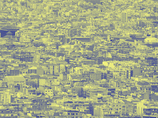 Fototapeta premium blue and yellow duotone crowded urban cityscape background with hundreds of densely packed buildings