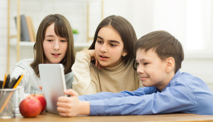 Break At School. Children Playing On Tablet Computer